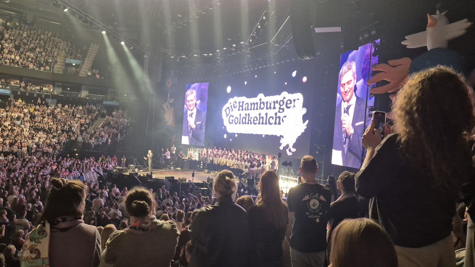 Ausverkaufte Arena mit Bühnenshow und LED-Leinwänden